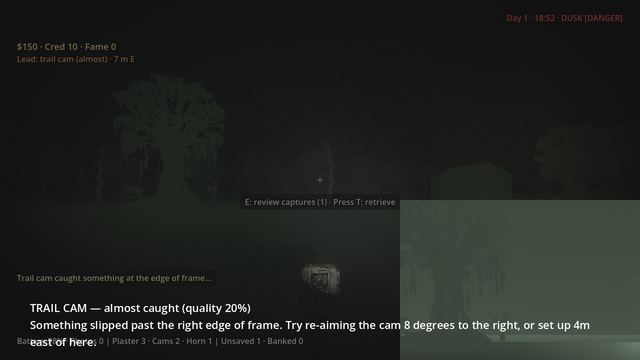 A trail cam on the ground with an almost-caught notice and its preview image